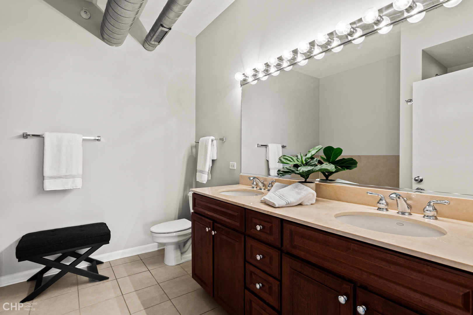 1200 West Monroe Street, Unit 805 Chicago, IL 60607 - Photo 13 of 18 a bathroom with a granite countertop sink a toilet and a mirror