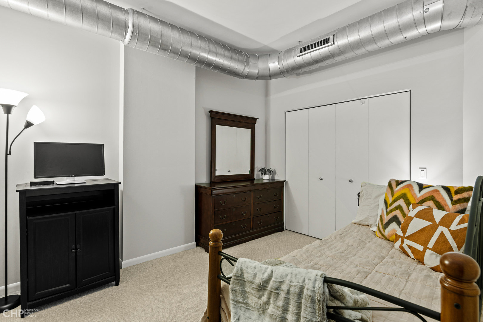 1200 West Monroe Street, Unit 805 Chicago, IL 60607 - Photo 14 of 18 a bedroom with a bed and a television
