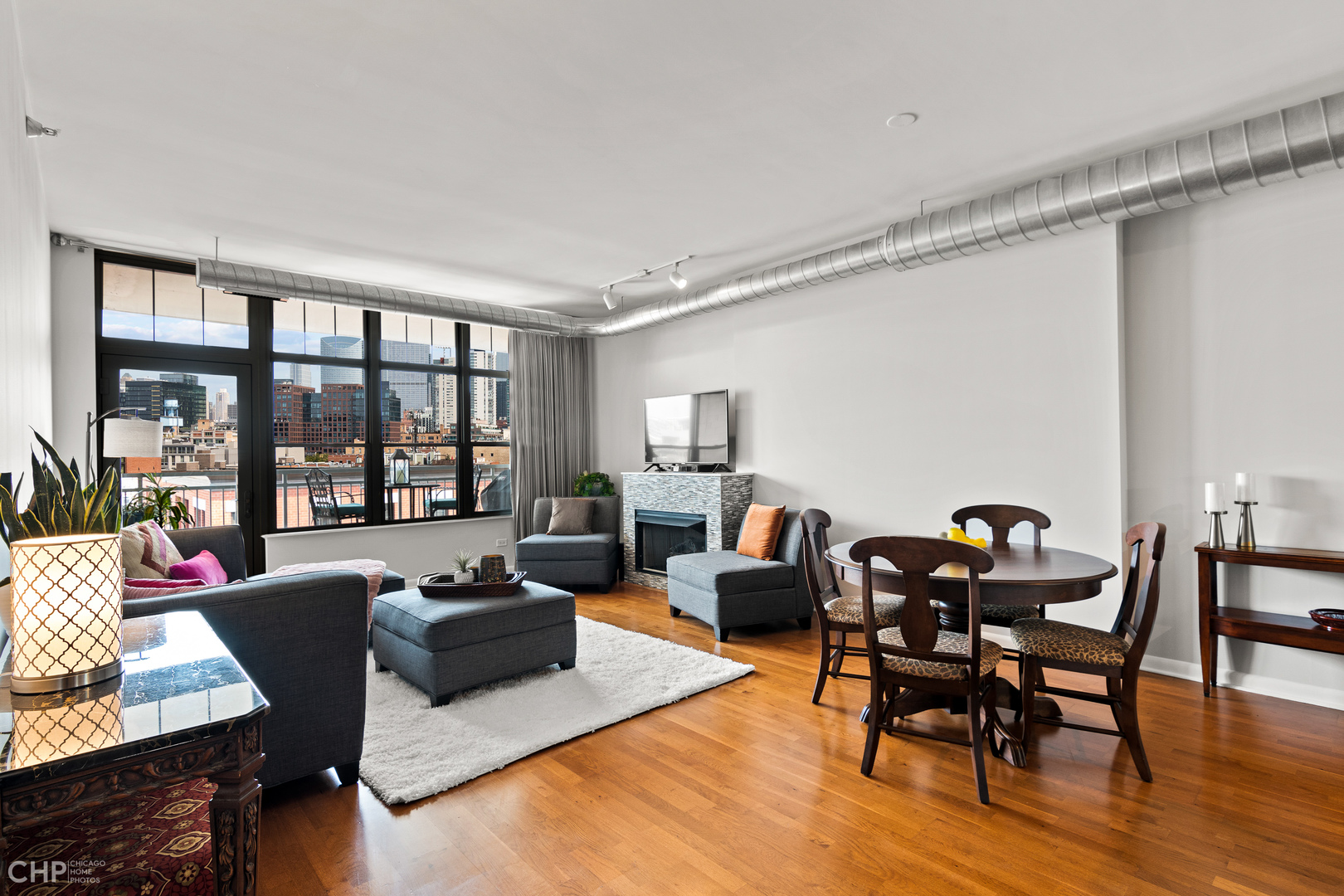 1200 West Monroe Street, Unit 805 Chicago, IL 60607 - Photo 5 of 18 a living room with furniture and floor to ceiling windows