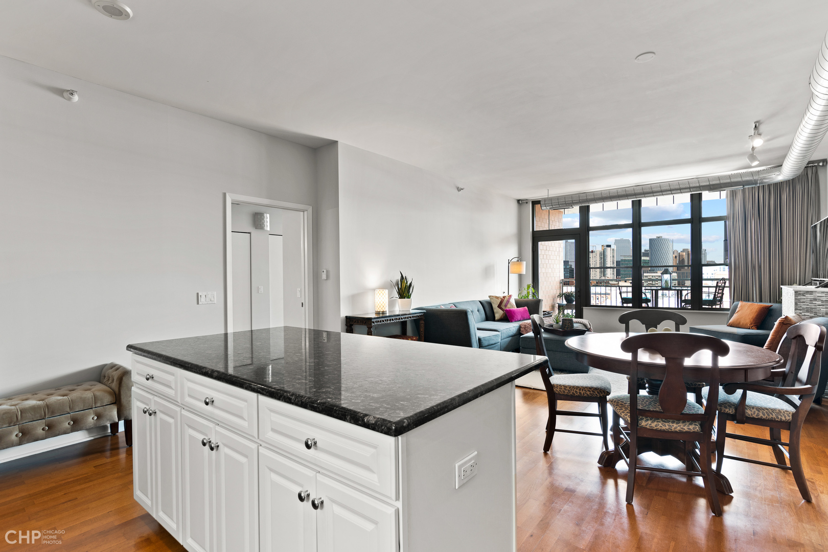 1200 West Monroe Street, Unit 805 Chicago, IL 60607 - Photo 6 of 18 a kitchen with granite countertop a table and chairs