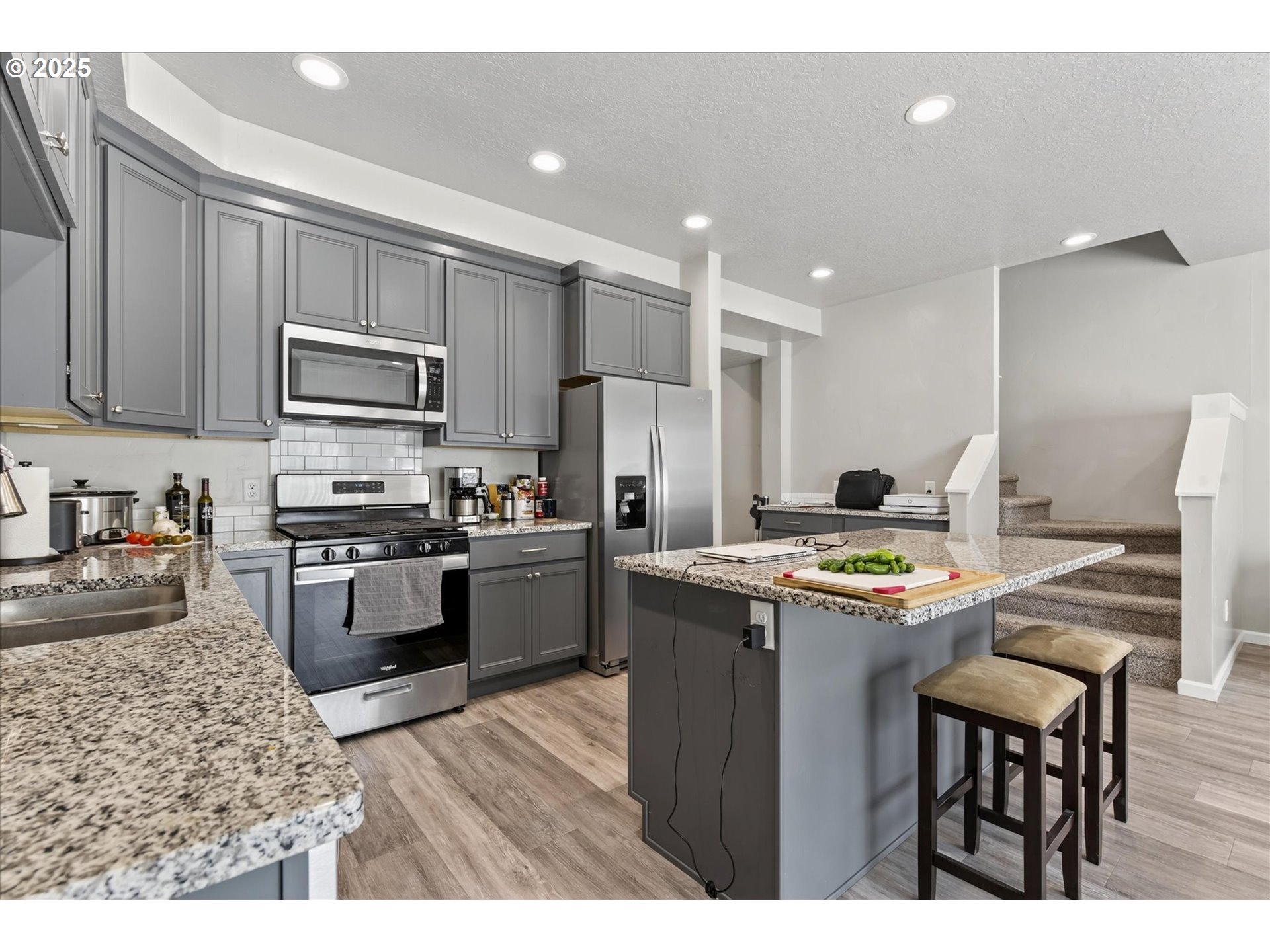 585 Baker Street Baker City, OR 97814 - Photo 15 of 36 a kitchen with kitchen island a stove a sink and a refrigerator