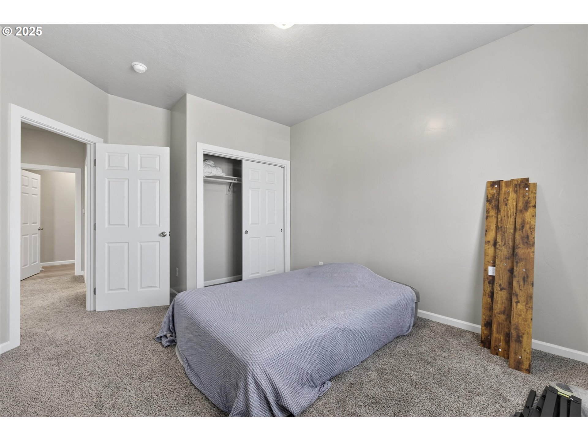 585 Baker Street Baker City, OR 97814 - Photo 24 of 36 a bedroom with a bed and a walk in closet