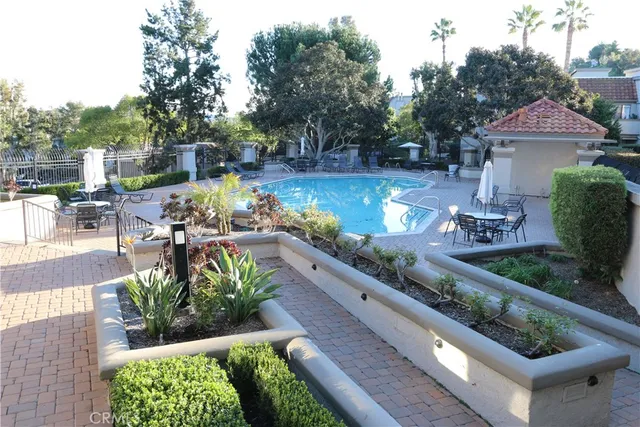 swimming pool view with a seating space