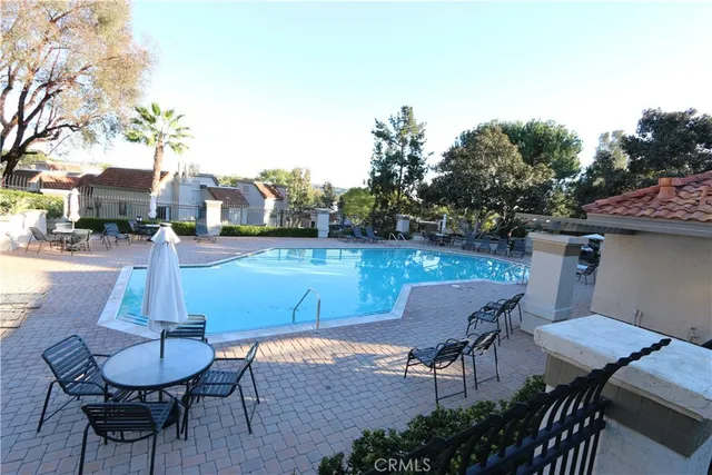 a swimming pool with outdoor seating and yard