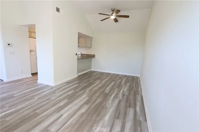 a view of empty room with wooden floor
