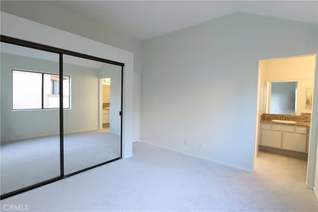an empty room with a bathroom and a sink
