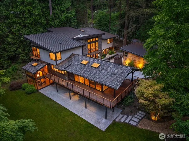an aerial view of a house with swimming pool and big yard