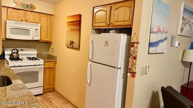 210 Sumner Avenue, Unit 5 Seaside Heights, NJ 08751 - Photo 6 of 20 a white refrigerator freezer and a stove sitting inside of a kitchen
