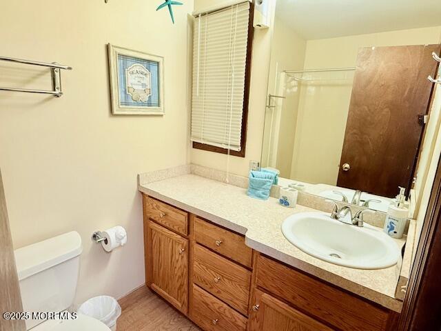 210 Sumner Avenue, Unit 5 Seaside Heights, NJ 08751 - Photo 10 of 20 a bathroom with a sink a toilet and a mirror