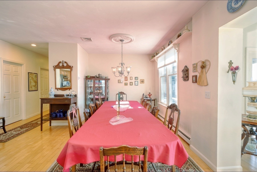 130 Scadding Street Taunton, MA 02780 - Photo 14 of 42 a living room with furniture a rug and a chandelier