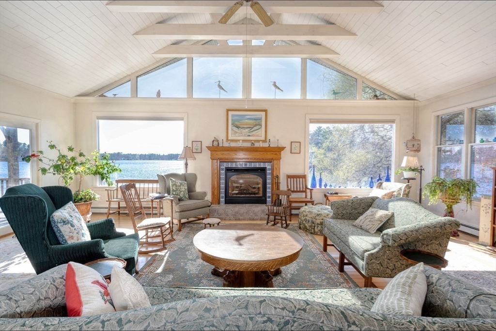 130 Scadding Street Taunton, MA 02780 - Photo 16 of 42 a living room with furniture a fireplace and a large window