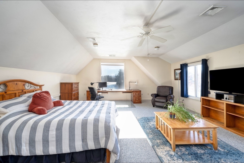 130 Scadding Street Taunton, MA 02780 - Photo 30 of 42 a bedroom with a bed a flat screen tv and couches