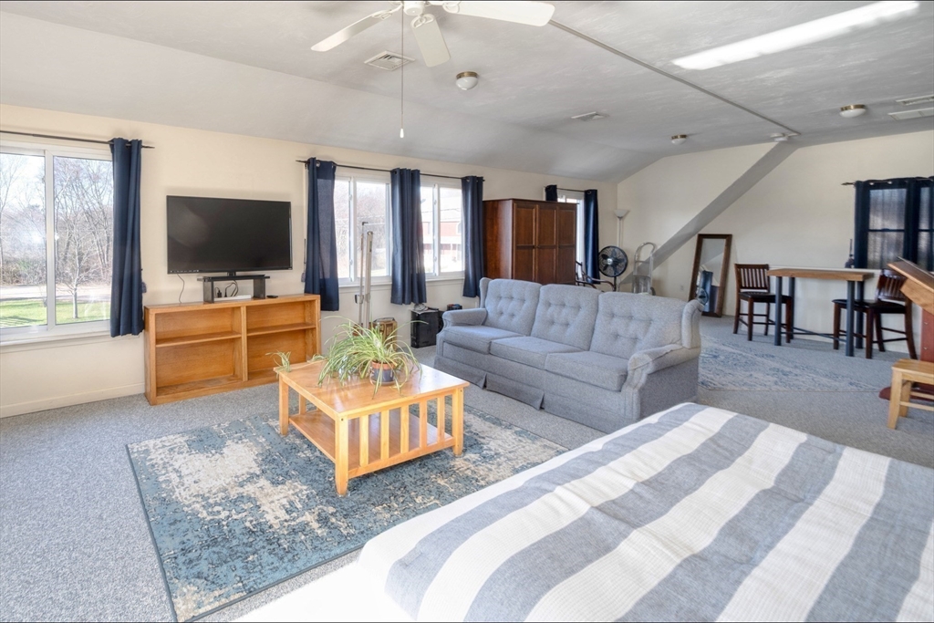 130 Scadding Street Taunton, MA 02780 - Photo 32 of 42 a living room with furniture flat screen tv and a large window