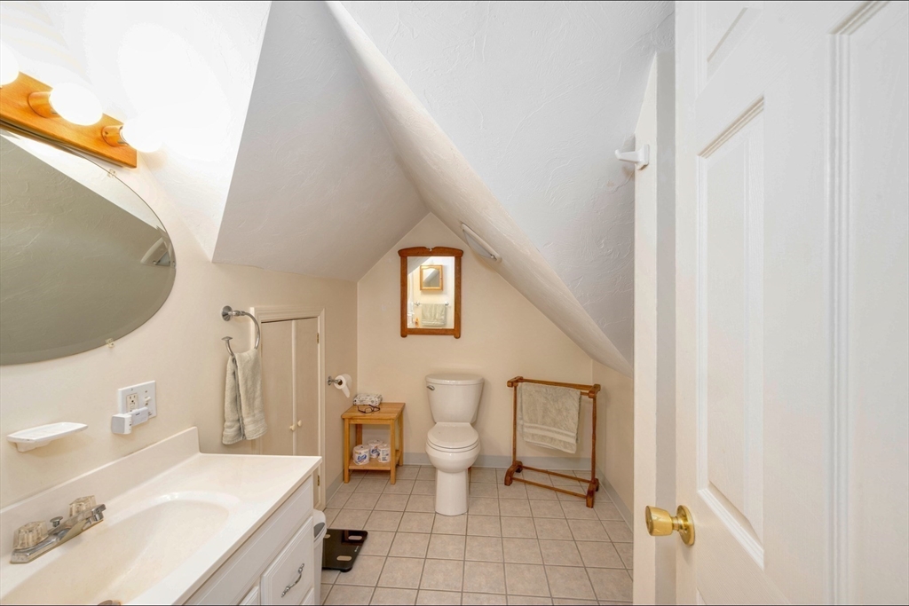 130 Scadding Street Taunton, MA 02780 - Photo 34 of 42 a bathroom with a sink a toilet and a mirror