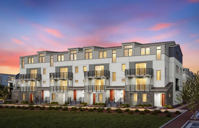 a front view of a residential apartment building with a yard