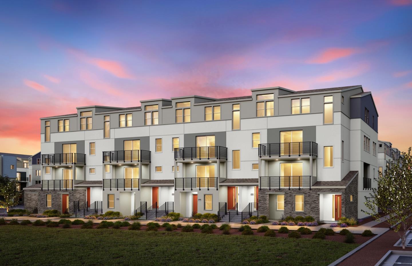 a front view of a residential apartment building with a yard