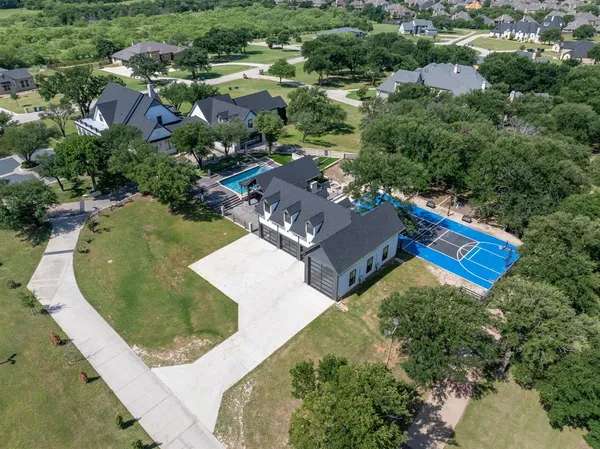 an aerial view of residential house with outdoor space and swimming pool