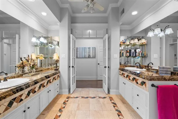 a large white kitchen with stainless steel appliances a stove a sink dishwasher and cabinets with wooden floor