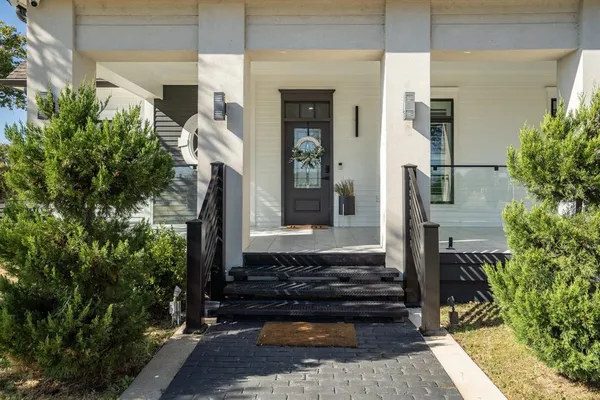 a front view of a house with a garden