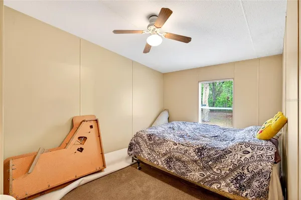 a bedroom with a bed and window