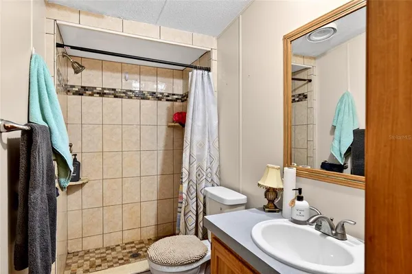 a bathroom with a sink toilet and shower