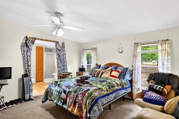 a bedroom with bed and window