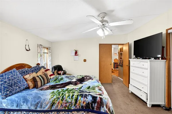 a bedroom with furniture and a flat screen tv