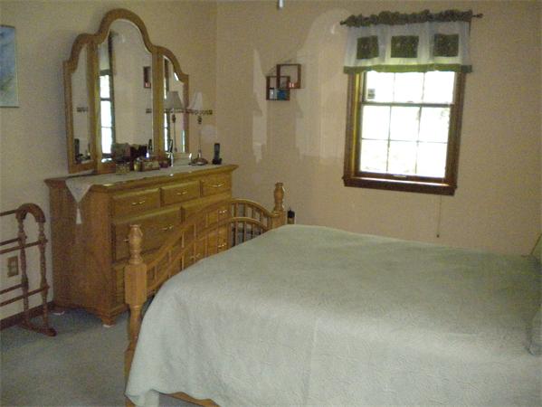 85 North Plain Road Sunderland, MA 01375 - Photo 11 of 13 a bedroom with a bed window and mirror