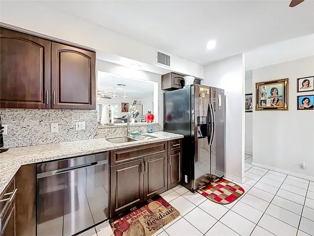 a kitchen with stainless steel appliances a sink stove and refrigerator