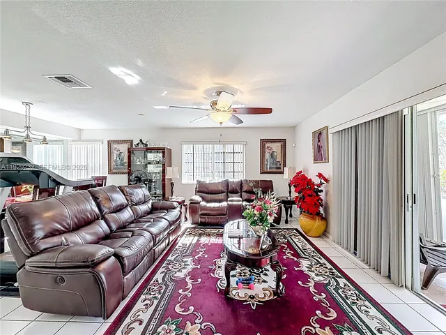 a living room with furniture fireplace and a window