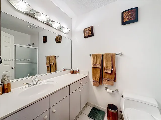 a bathroom with a sink mirror and vanity