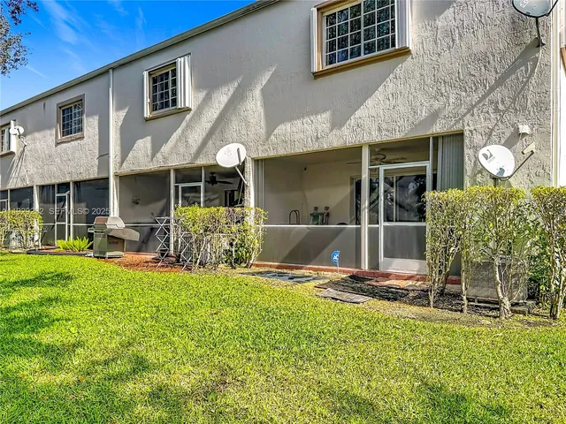 a view of a house with backyard porch and sitting area
