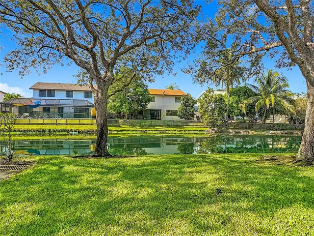a front view of a building with a garden
