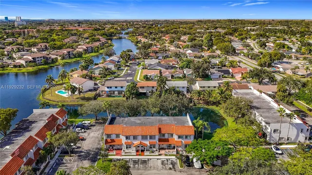 an aerial view of a house with a lake