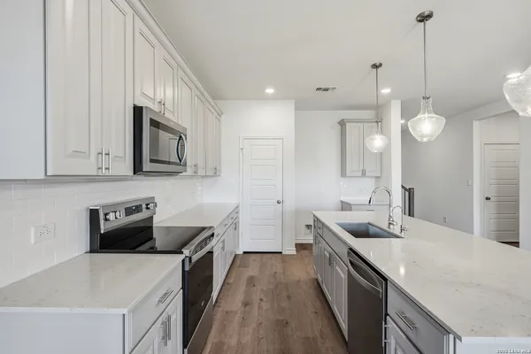 a kitchen with a sink stove and microwave