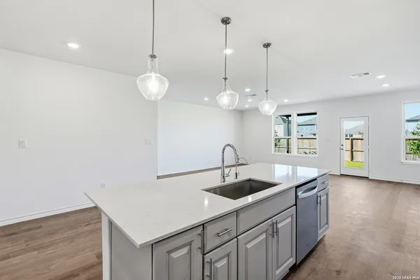 a kitchen with stainless steel appliances granite countertop a sink a oven and a counter space