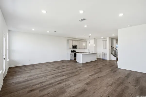 a view of kitchen with kitchen island wooden floor and center island