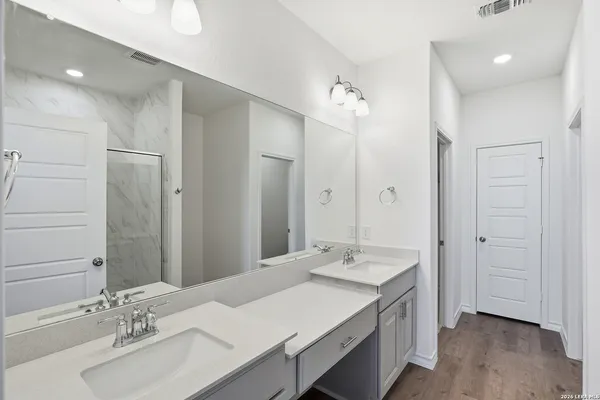 a bathroom with a sink double vanity and a mirror
