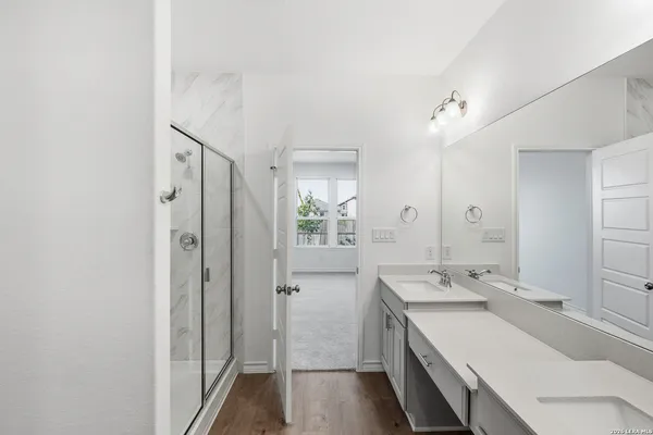a bathroom with a sink a mirror and a shower