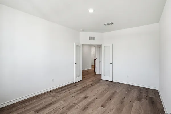 a view of a room with wooden floor and a sink