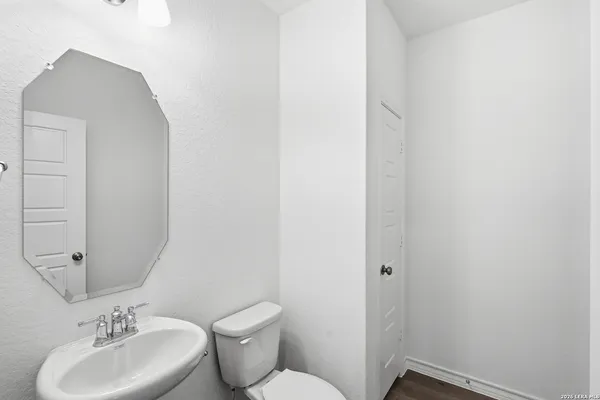 a bathroom with a toilet sink and mirror