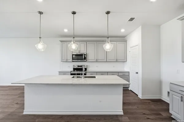 a large kitchen with stainless steel appliances