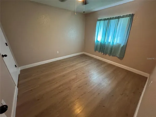 a bathroom with a granite countertop sink toilet a mirror and bathtub