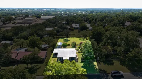 an aerial view of a house with yard