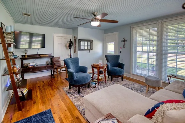 a living room with furniture and a flat screen tv