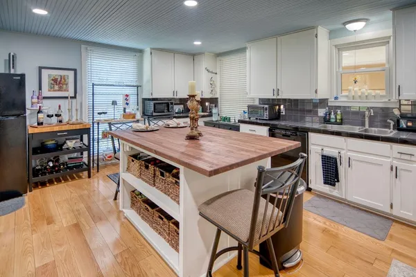 a kitchen with a stove a refrigerator and a dining table