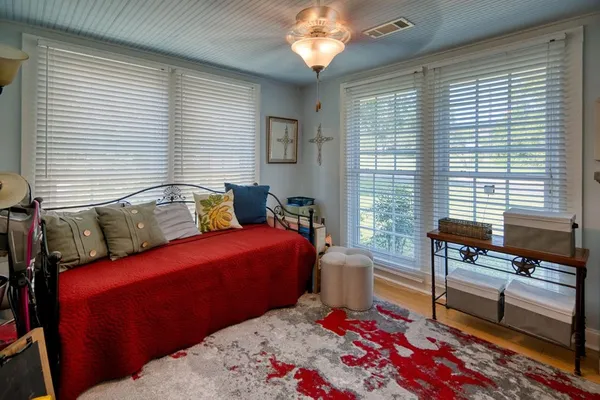 a bedroom with furniture and a window