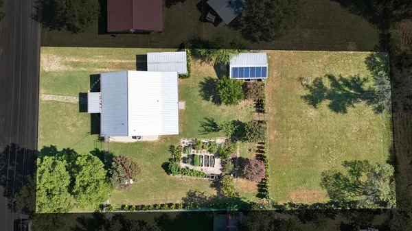 an aerial view of residential house with outdoor space and swimming pool