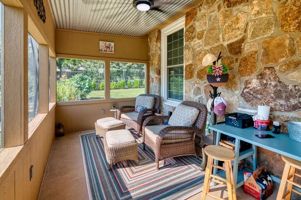 a outdoor living space with furniture and a floor to ceiling window