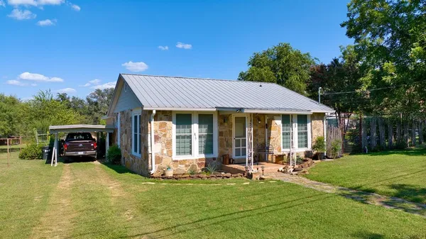a view of a house with swimming pool and a yard